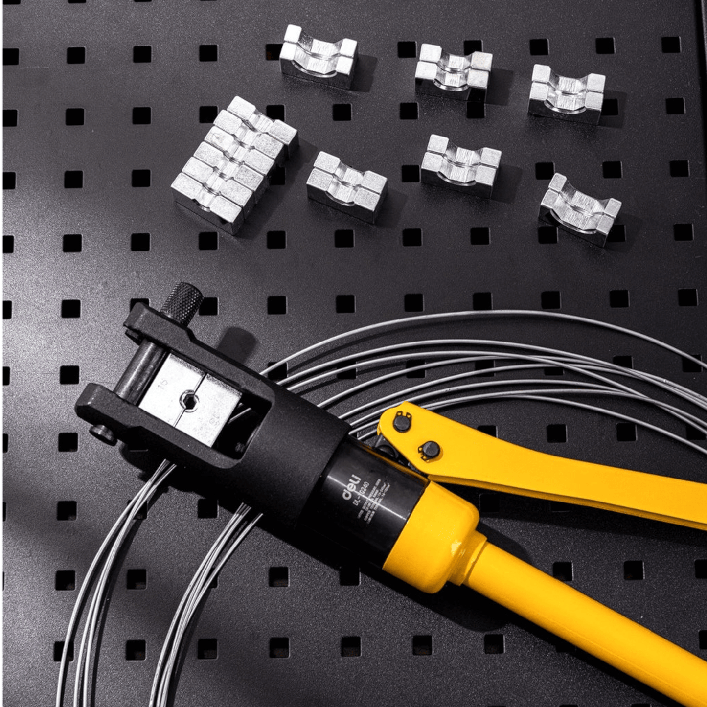DL-YQ120 Hydraulic Crimping Plier 10-120mm (DELI) on a metal surface with crimping accessories.